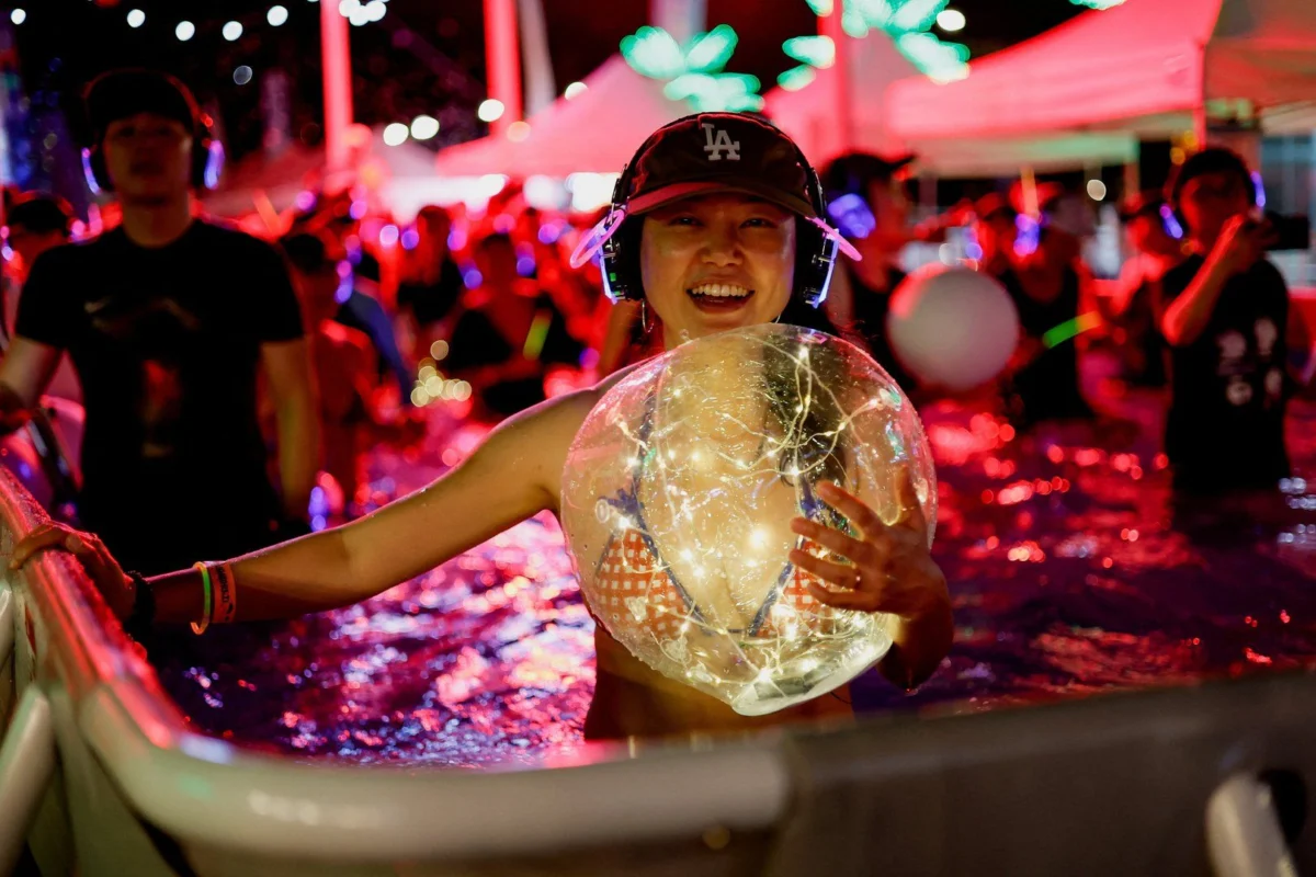 South Koreans cool off with silent disco pool party amid heat wave