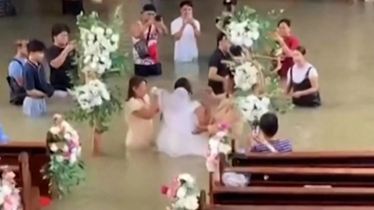 Bride walks down the aisle despite waist-deep flooding in the Philippines